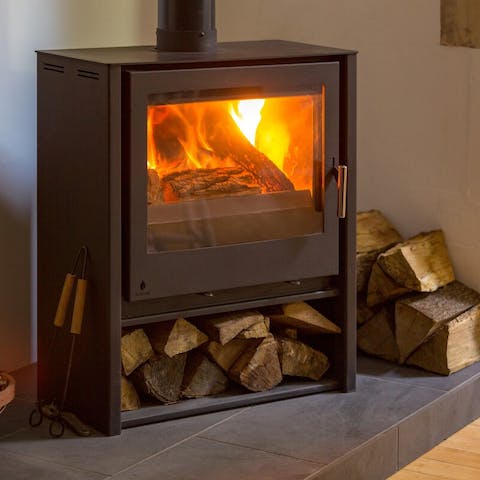 Get cosy by the wood-burning stove on chilly evenings