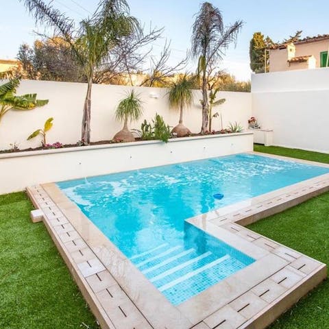 Cool off from the Mallorcan sun in the private pool with its palm backdrop