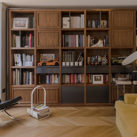 Peruse the selection of books on display in the living room