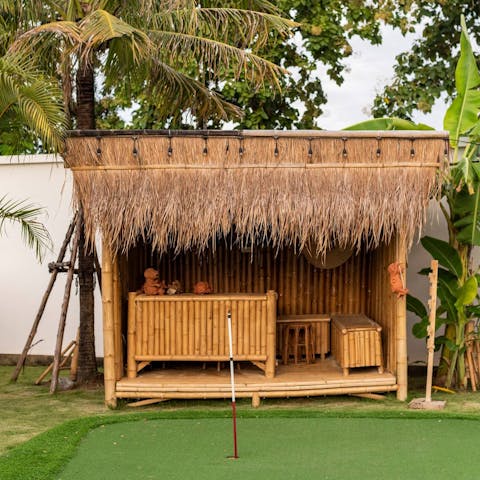 Challenge your friends to a round of golf or simply enjoy a cool drink in the bamboo bar 