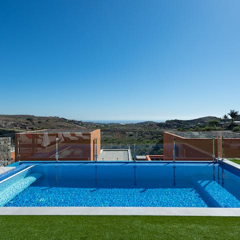 Cool off in the crystal-clear swimming pool, admiring the sparkling Atlantic Ocean in the distance