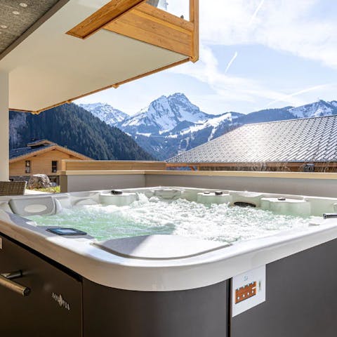 Enjoy views of the snow-capped peaks from the bubbles of your hot tub
