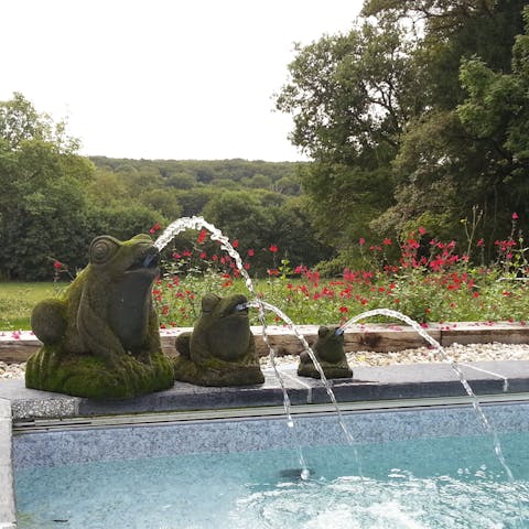 Take a dip in the fountain-fed swimming pool with the forest stretching before you