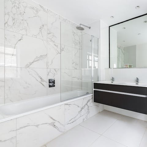 Relax and unwind under the marble bathroom's rainfall shower
