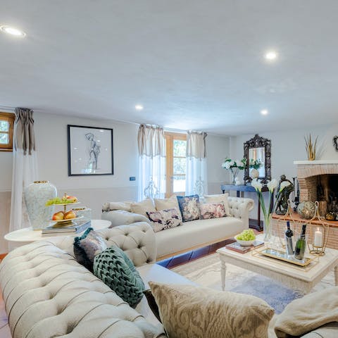 Recline on the comfortable cream couches in the elegant living space