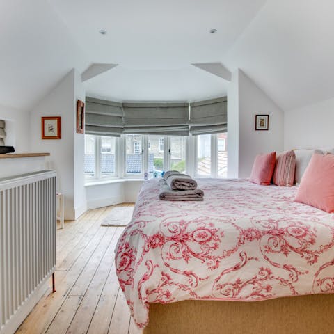 Wake up to sunlight through big bay windows in the main bedroom