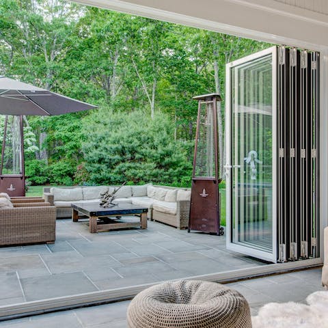 Open the bi-fold doors to the seating area with its patio heater