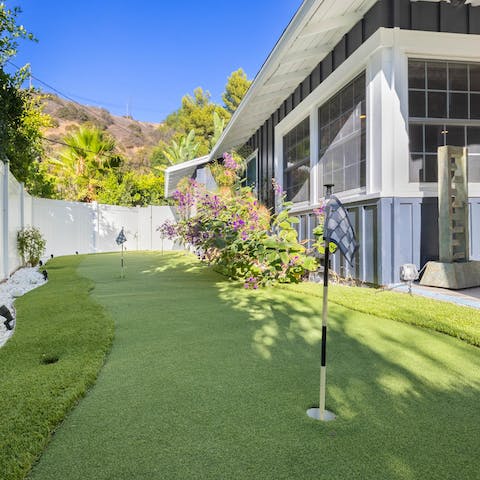 Hone your putting on the green that runs along the side of the home
