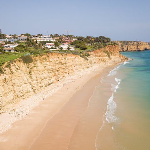 Take a twenty-minute walk to Porto de Mós beach