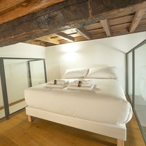 Drift off under the original beams in the mezzanine bedroom