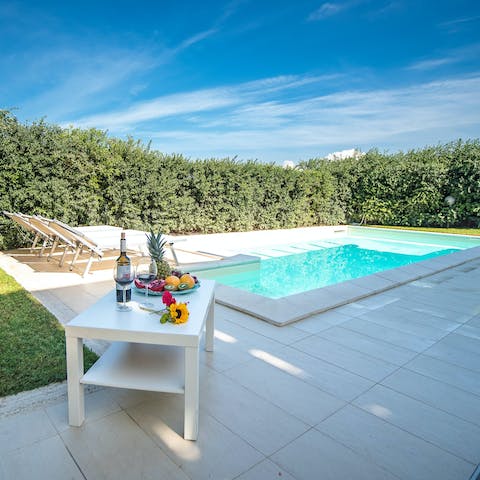 Relax beside the private pool, revelling in the pretty garden