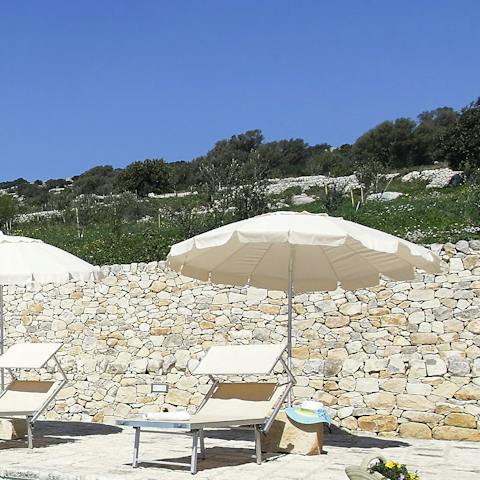 Soak up the Sicilian sunshine from the poolside loungers 
