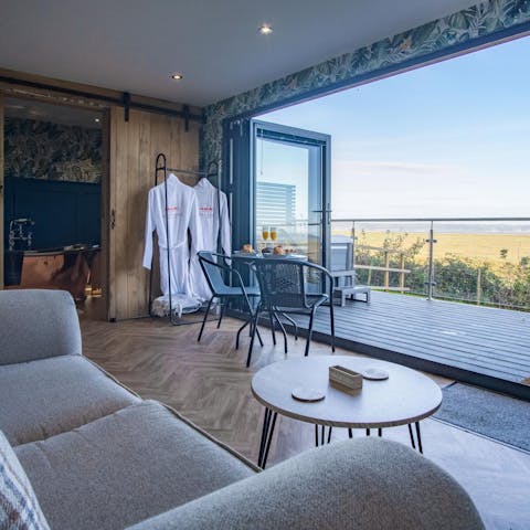 Take in the views over the marshes and sea from the comfy sofa