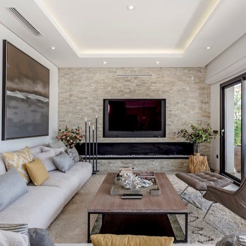 Indulge in a movie night with loved ones in your chic living room