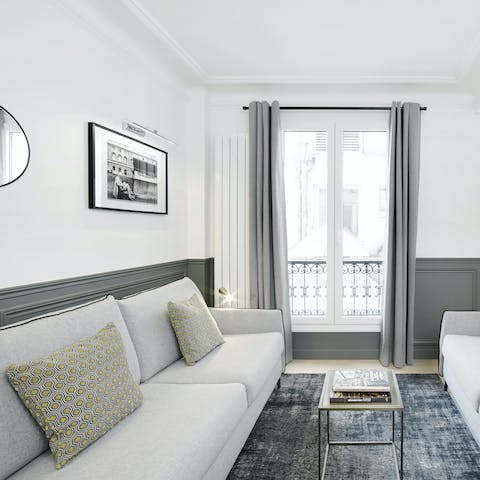 Enjoy a glass of wine and some people-watching by the living room's Juliet balcony