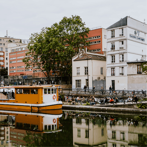 Stroll along the Canal Saint-Martin lined with waterside cafés, a fifteen-minute walk away