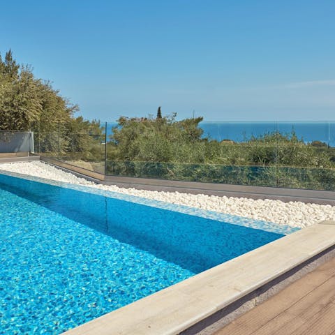 Plunge into the depths pf the villa's private pool overlooking sea views