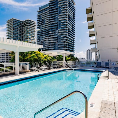 Dive into the refreshing waters of the communal pool after a sun-soaking session