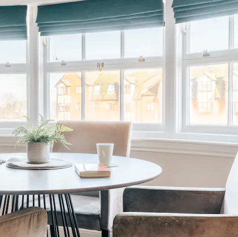 Enjoy your morning Earl Grey by the trio of huge windows in the living space