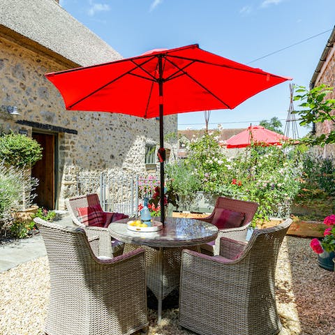Gather beneath the cherry red umbrella for long alfresco lunches
