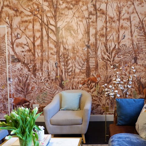 Admire the forest-themed wall mural as you relax in the living room