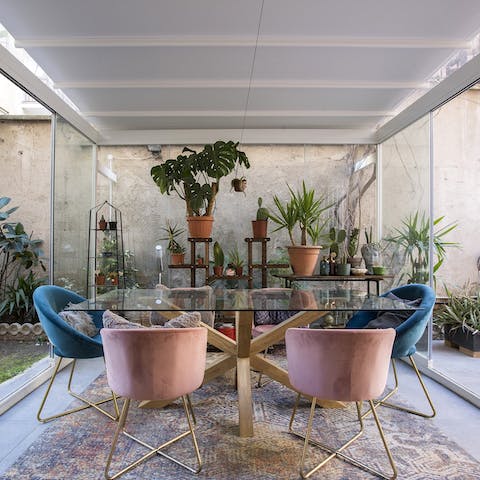Gather together for an elegant meal in the plant-filled conservatory