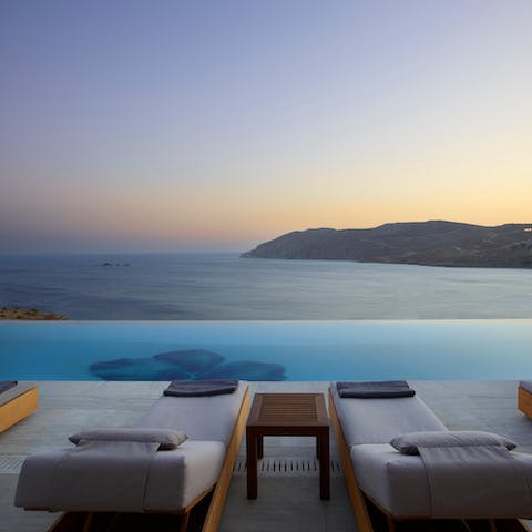 Watch the Aegean sunset from the edge of the infinity pool