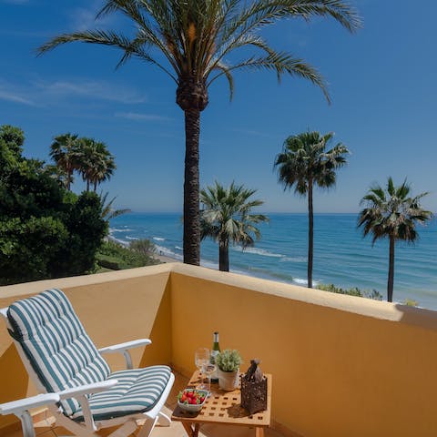 Enjoy beautiful sea views speckled with leafy palm trees