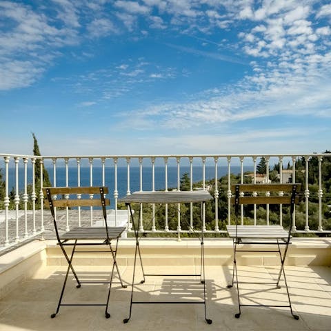 Toast your getaway with a glass of Grecian wine on the balcony