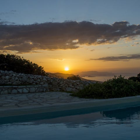 Watch the sun set over the island from your pool