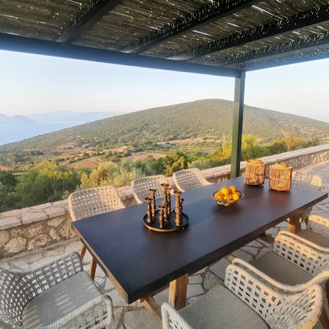 Dine alfresco on the covered terrace overlooking the hillside