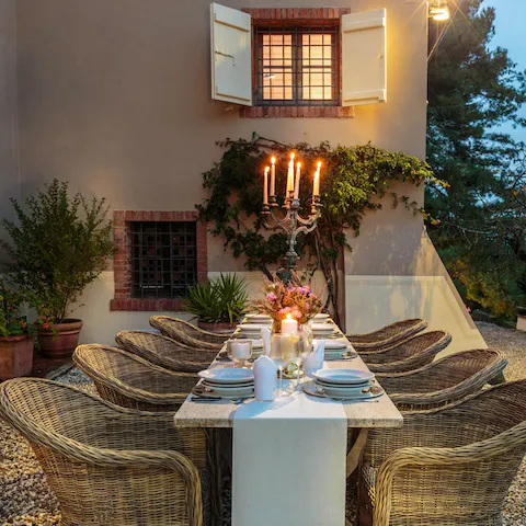 Enjoy dinner by candlelight outdoors as twilight falls