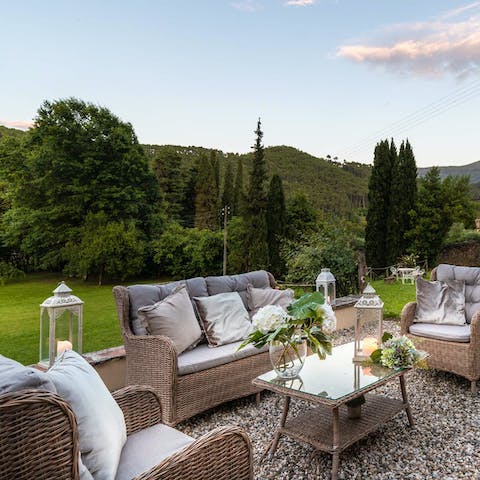 Take in the typically Tuscan scene of hills and cypress trees from the lounge seats