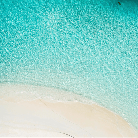 Soak up the sun from your building's private beach, a short walk away