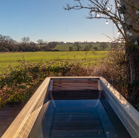 Look out over rolling fields from the warmth of the wood-fired tub