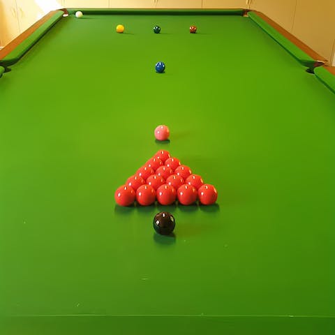 Rack up a game of snooker on the full-sized table in the games room