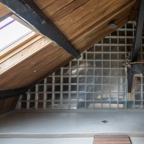 Freshen up in this unique bathroom in the eaves of the building