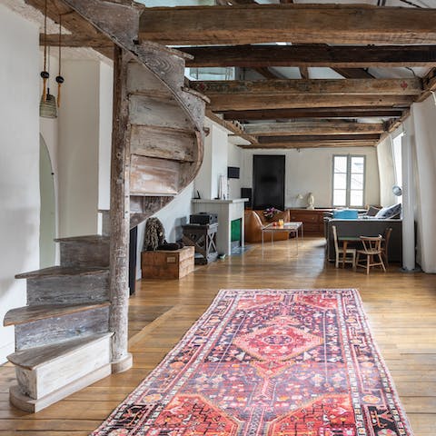 Head up the original, wooden spiral staircase above the rustic beams