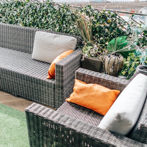 Relax outdoors on the plant-filled private balcony 