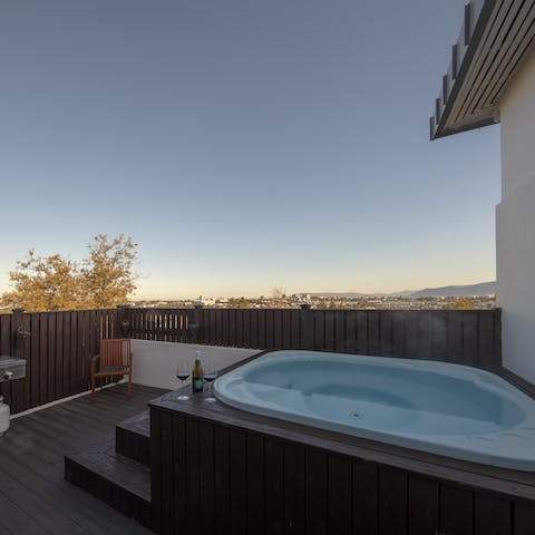 Sink into the luxurious hot tub with a drink and admire the scenic surroundings
