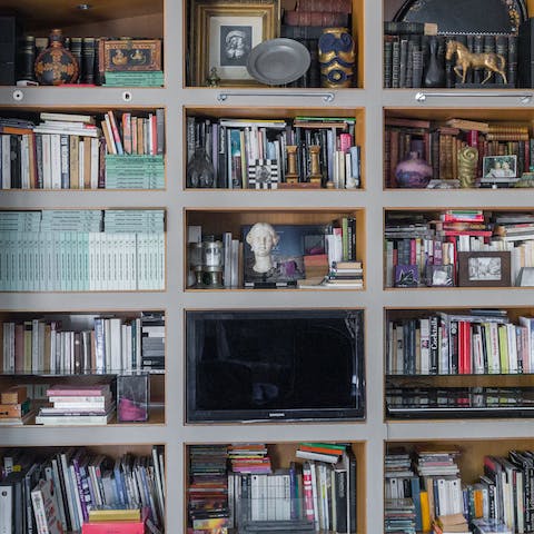 Pick a novel to read from the host's extensive library of books