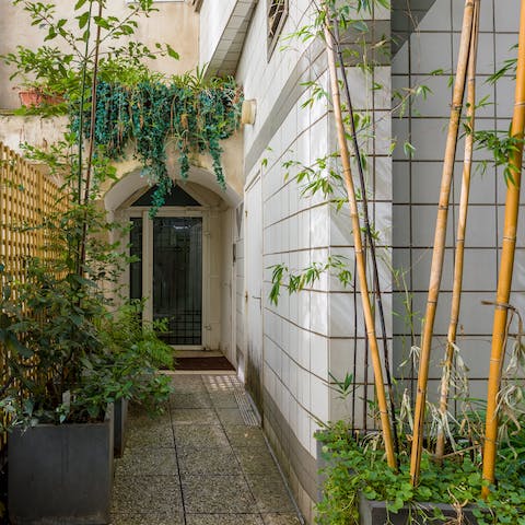 Arrive in style at the bamboo-clad entrance to the home