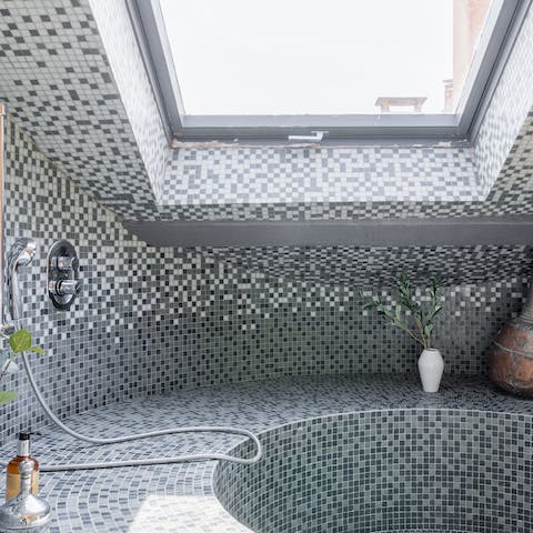 Step into the tiled masterpiece of this unique shower