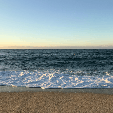 Bask in the sunshine on Agios Stefanos Beach, reached by car