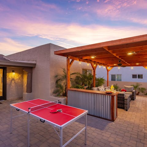 Play a game of ping pong by the outdoor bar