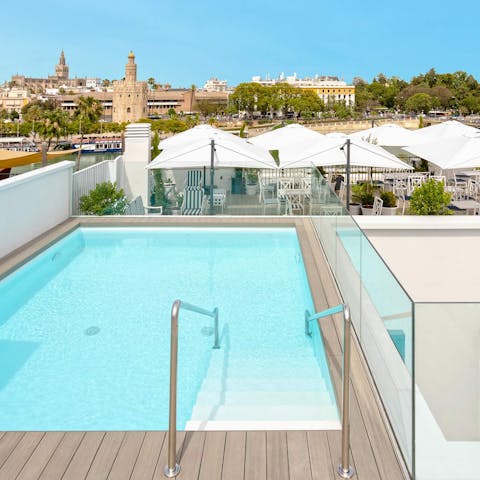 Admire the lovely views of Torre del Oro from the shared pool