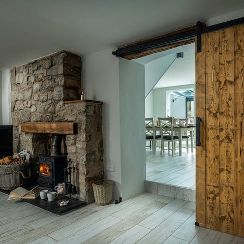 Slide the thick, wooden doors closed to keep cosy by the wood-burning stove