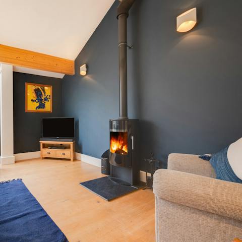 Keep toasty by the roaring wood-burning fire in the cosy living area