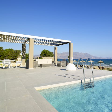 Lounge under parasols beside the Aegean