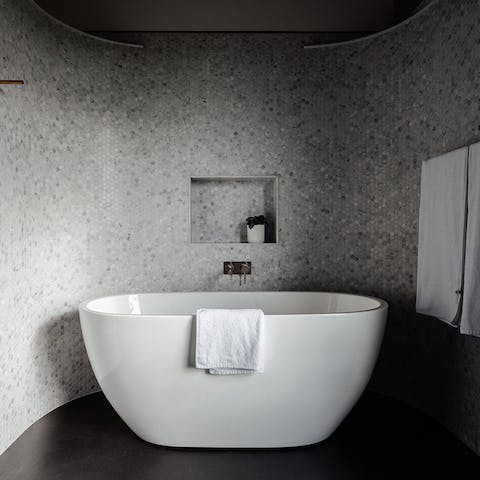 Treat yourself to an extra-long soak in the elegant freestanding bathtub